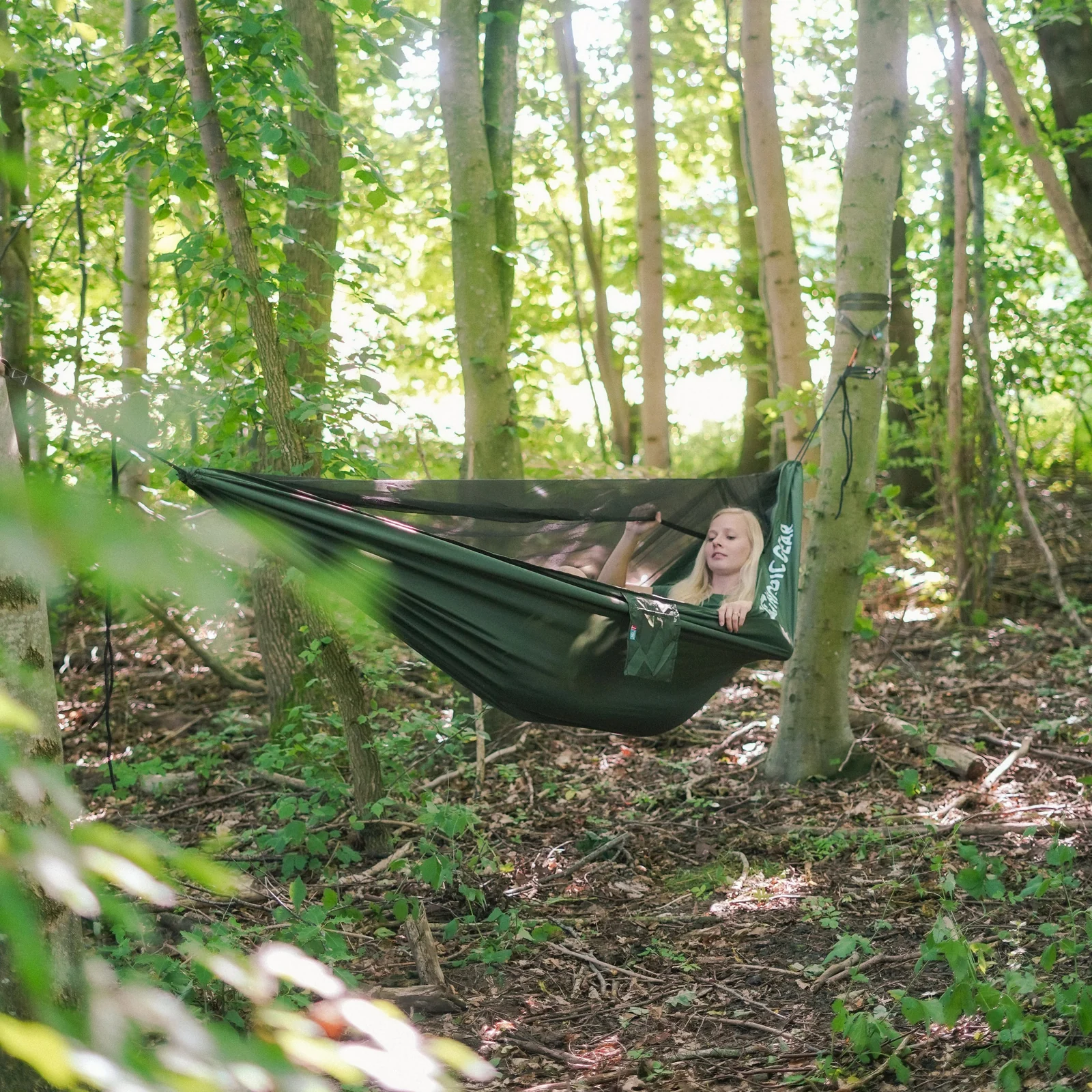 Camper relaxing in a forest hammock